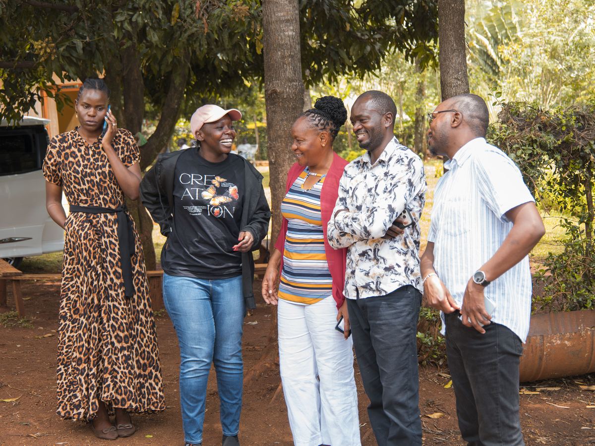 Team members talking beside a vehicle on arrival