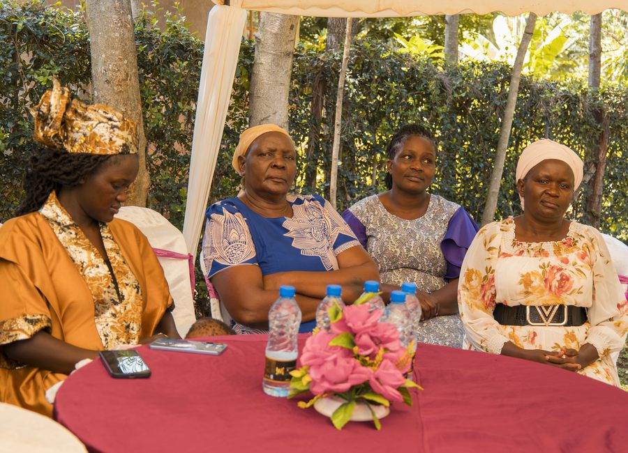 Women seated together at a community meeting